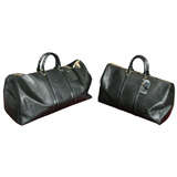 A pair of Lois Vuitton grained black duffle bags